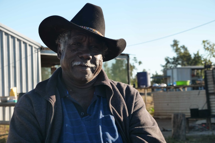 Frank Shadforth is sitting down infront of a camera with a cowboy hat.