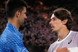 Tennis players Novak Djokovic and Alex de Minaur congratulate each other over the net at the Australian Open.