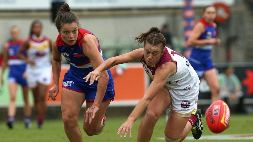Ellie Blackburn and Jamie Stanton compete for the ball in the AFLW grand final.