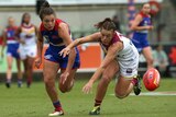 Ellie Blackburn and Jamie Stanton compete for the ball in the AFLW grand final.