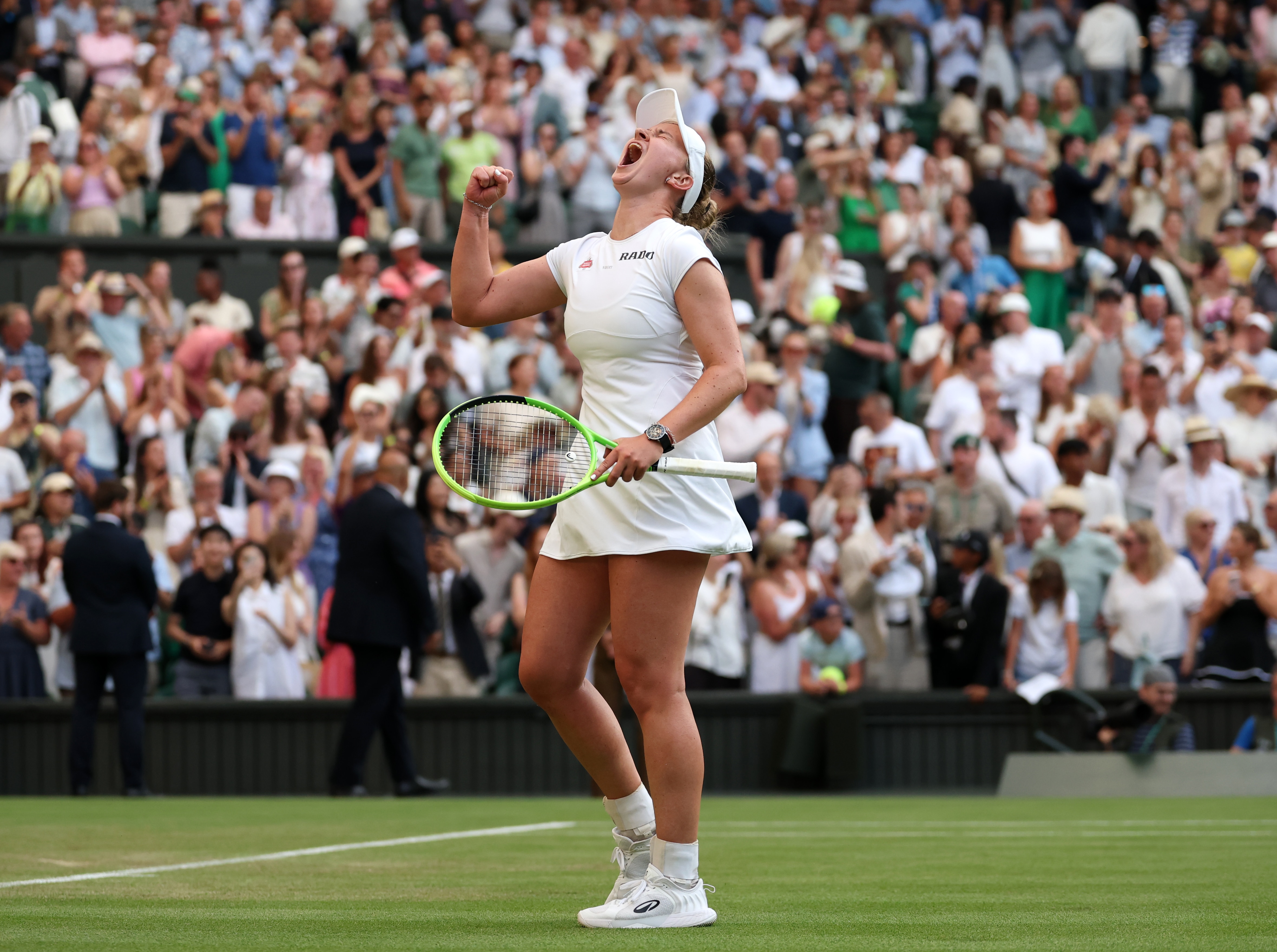 Barbora Krejcikova roars into the air to celebrate at Wimbledon.
