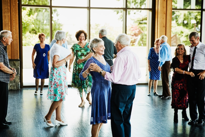Group of elderly people dancing in couples 