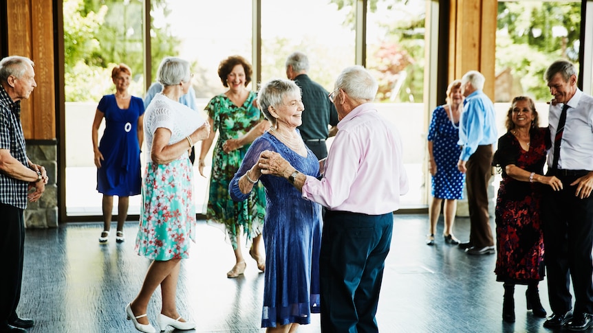 A group of older people dancing in couples 