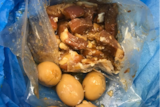 Picture of imported pork in a plastic bag next to eggs.