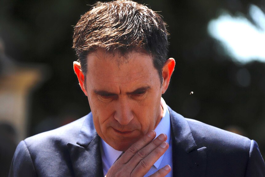 Cricket Australia CEO James Sutherland looks downwards during a media conference.