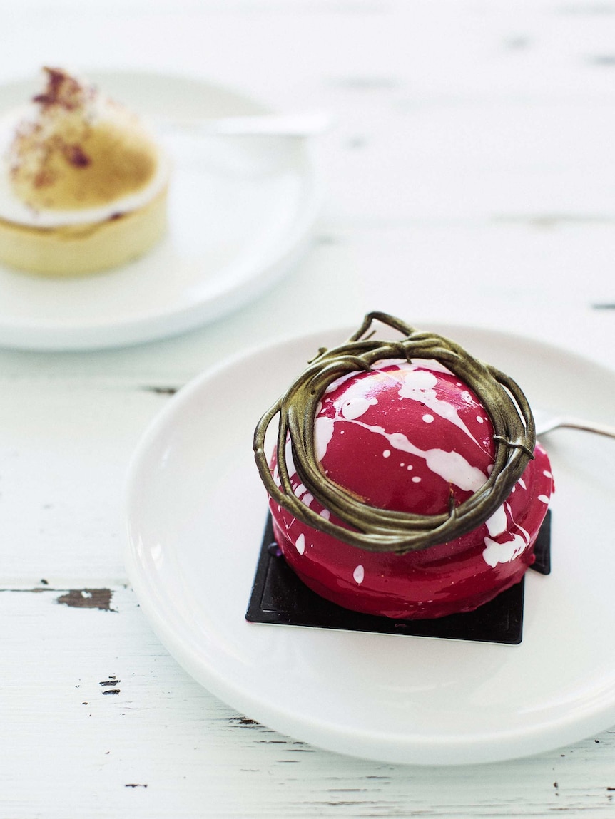 Close-up of a red puddling dessert on a white plate and table to depict food photography tips.