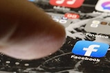 A phone with the Facebook logo on its home screen