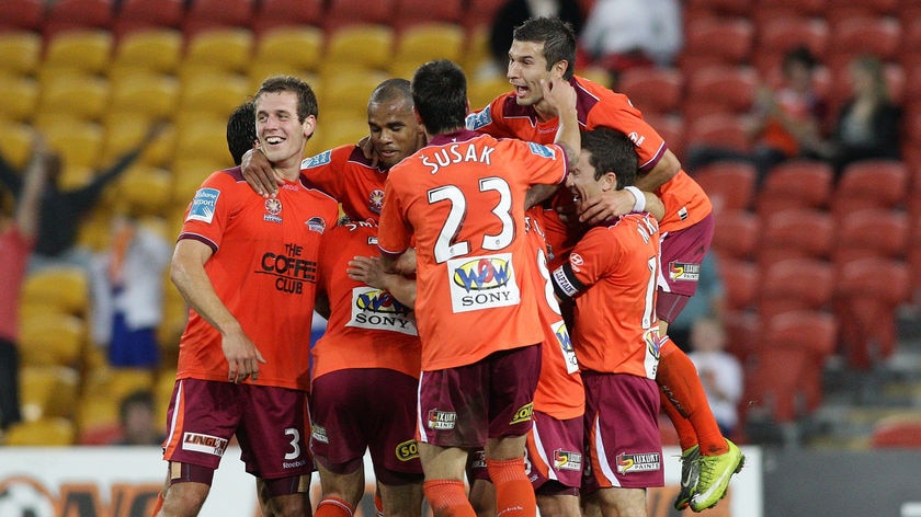 Goal-fest...the Roar celebrate Erik Paartalu's first-half score.