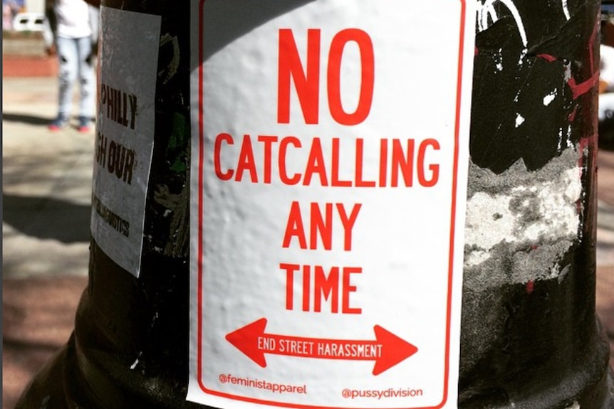 An anti-street harassment poster reads, 'No catcalling any time'.