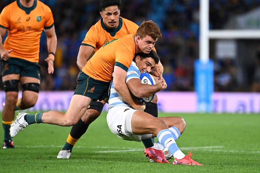 A Pumas player is tackled by a Wallabies opponent during a Rugby Championship Test.