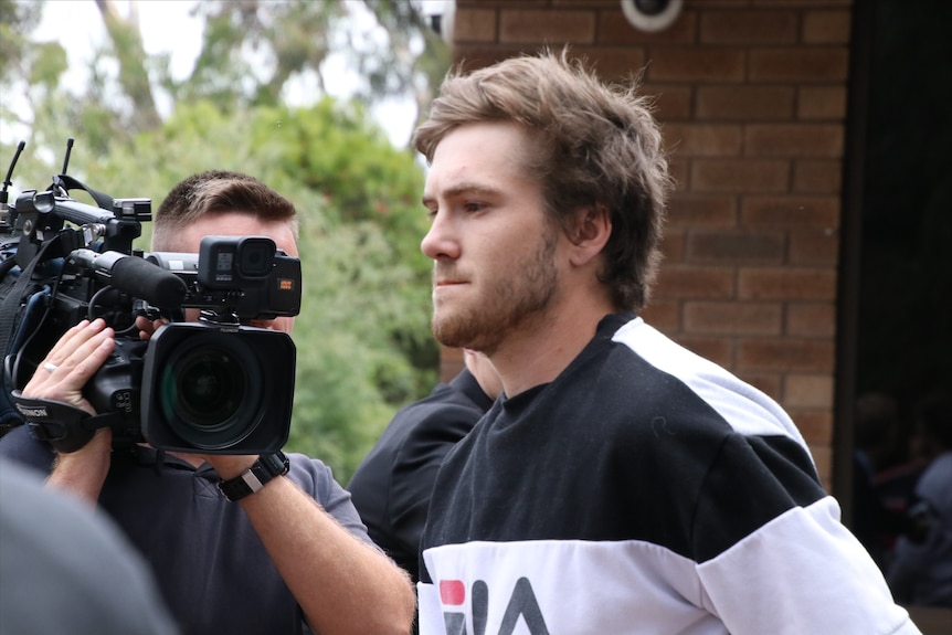 A close up of Zayvier Tamer Rose pictured next to a news camera