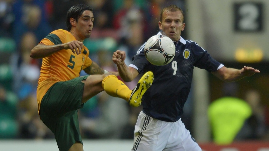 Rhys Williams (L) plays for the Socceroos against Scotland last year.