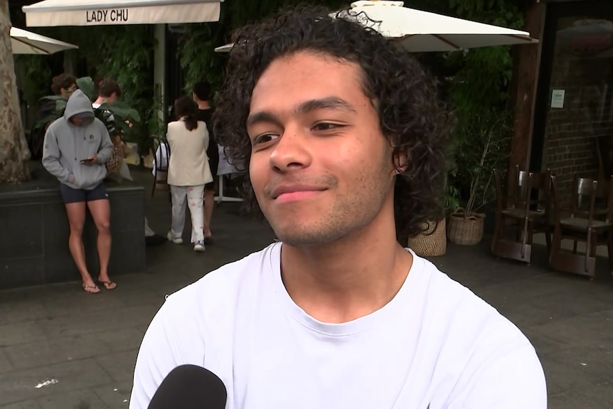 Hector Farraera in a white shirt outside of the Darlinghurst hostel.