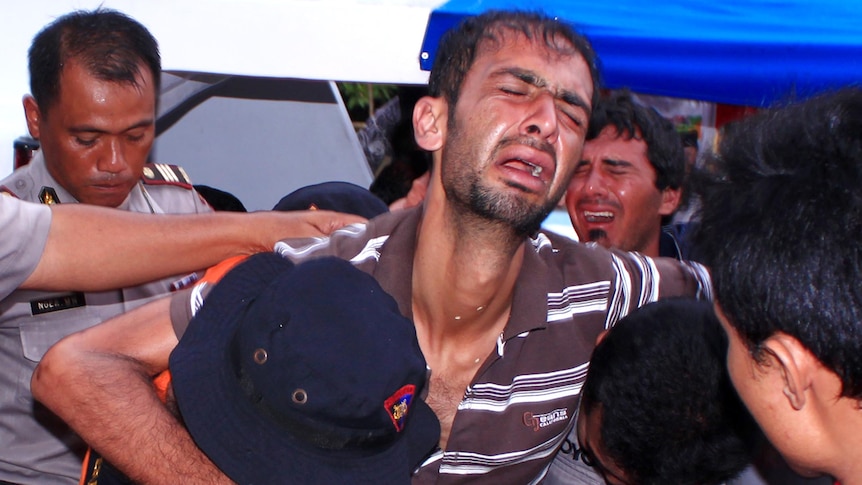 Asylum seekers helped after boat sinking (AFP)