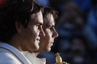 Roger Federer and Rafael Nadal hold their trophies after Nadal beat Federer