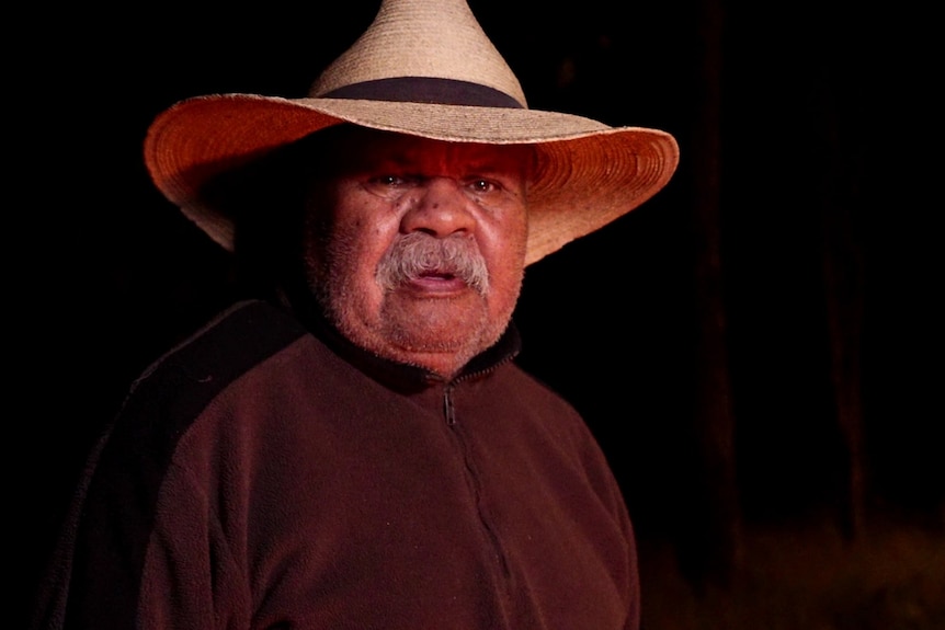 Harry Gertz wears a wide-brimmed hat and has a moustache