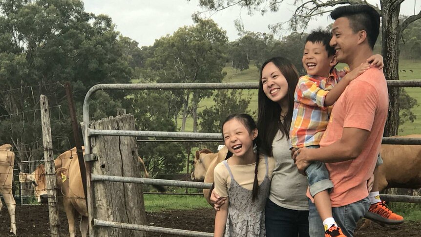 People visiting a dairy farm outside of Brisbane.