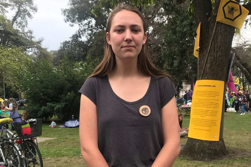 Kitty Anne Cardigg stands in Carlton Gardens near the Extinction Rebellion camp.