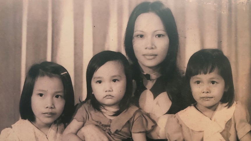 Sepia portrait photograph of Asian woman with three daughters