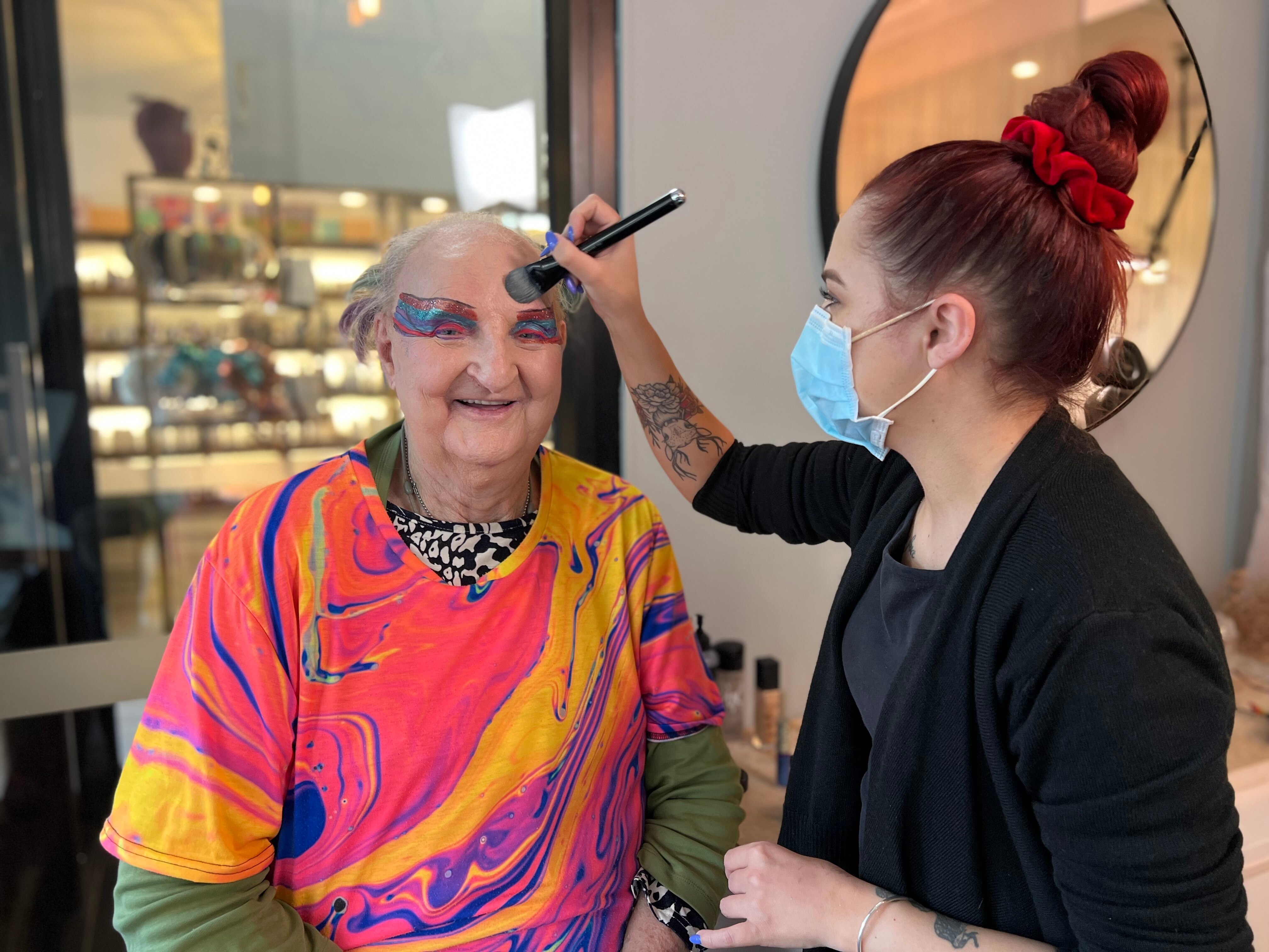 Michelle gets her makeup done by a makeup artist.
