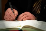 A person signs a document