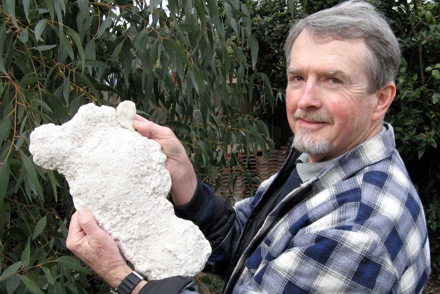 Man holds cast of large footprint