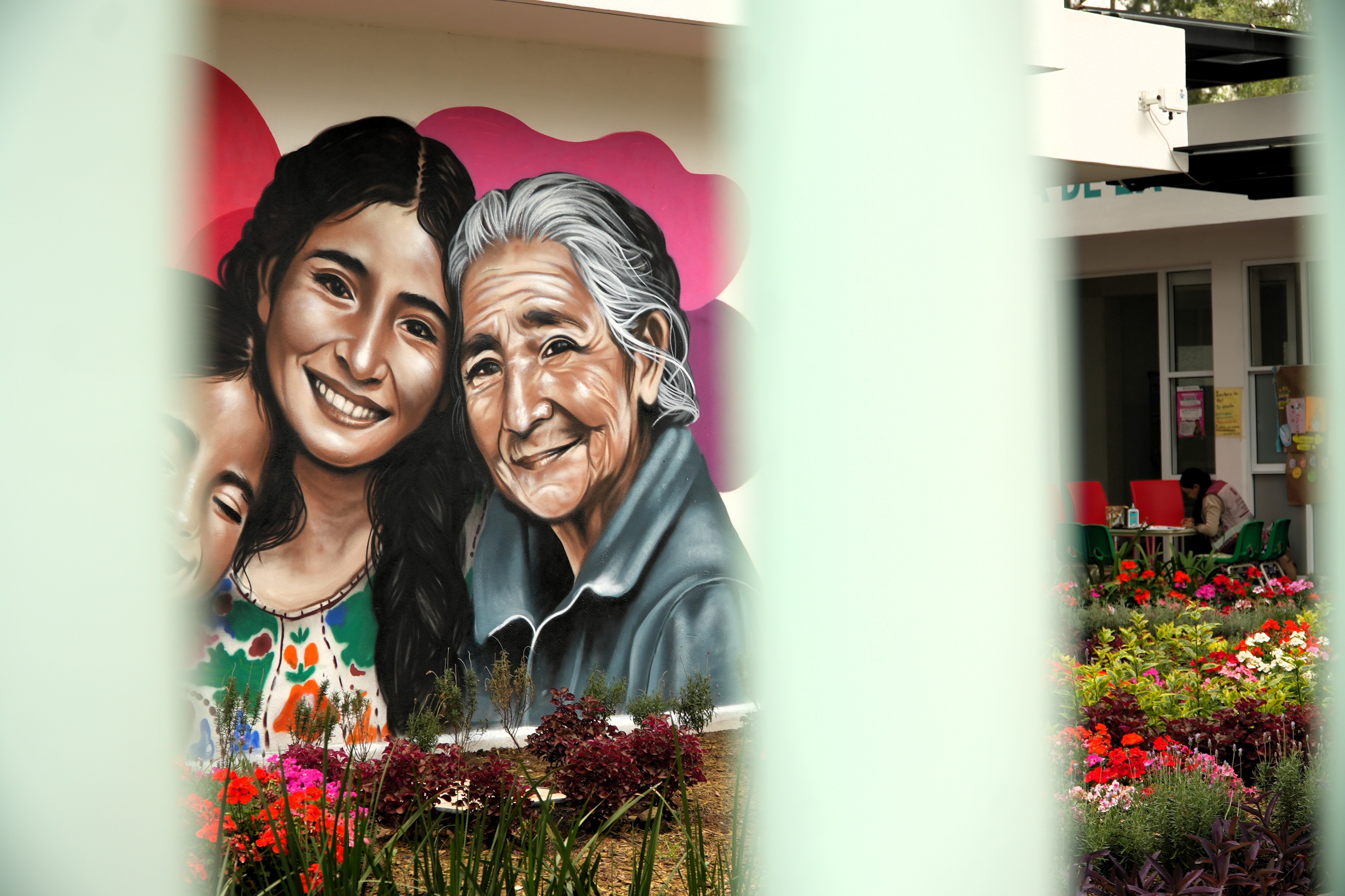 A mural depicting three women.