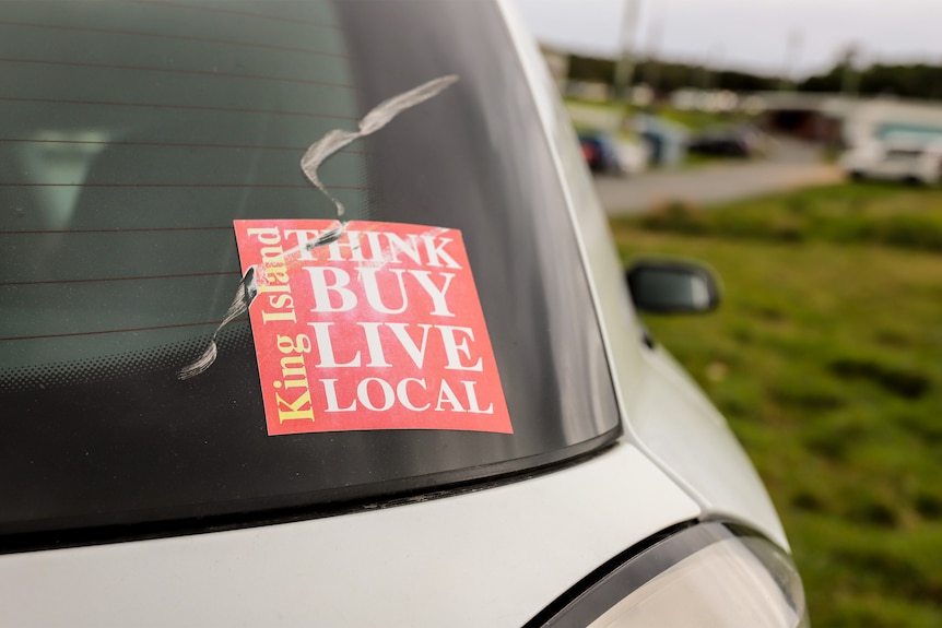 A faded car sticker that reads King Island: Think Buy Live Local