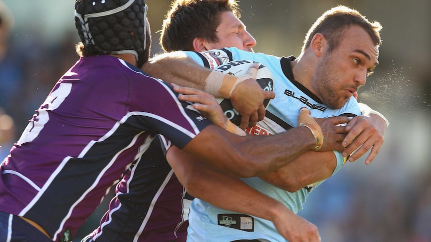 Isaac Gordon is tackled whlie playing for the Sharks