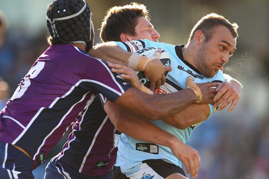 Isaac Gordon is tackled whlie playing for the Sharks