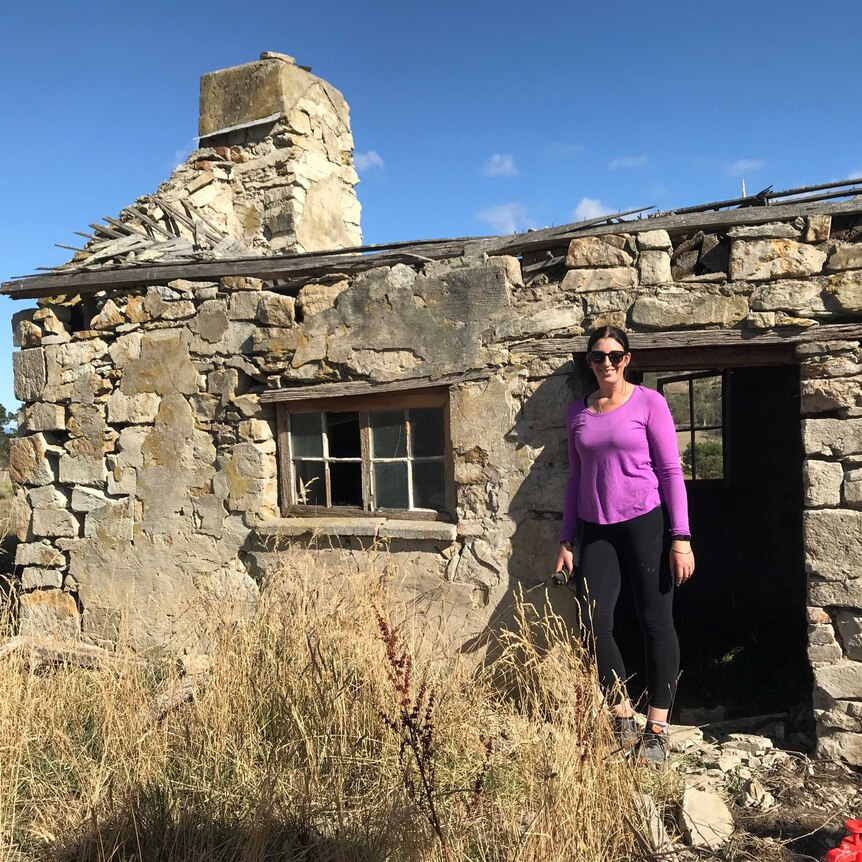 Farmer Clare Dean in the dilapidated stone house on her farm that she's repairing.