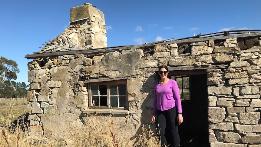Farmer Clare Dean in the dilapidated stone house on her farm that she's repairing.