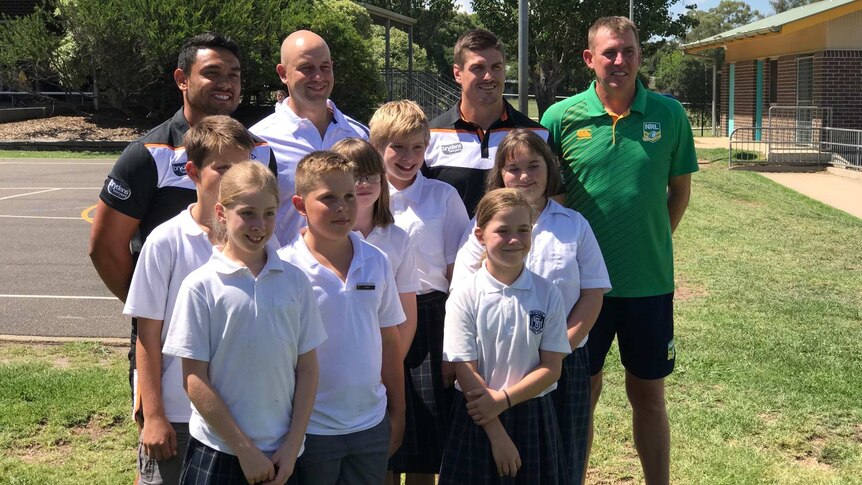 Todd Greenberg poses with children