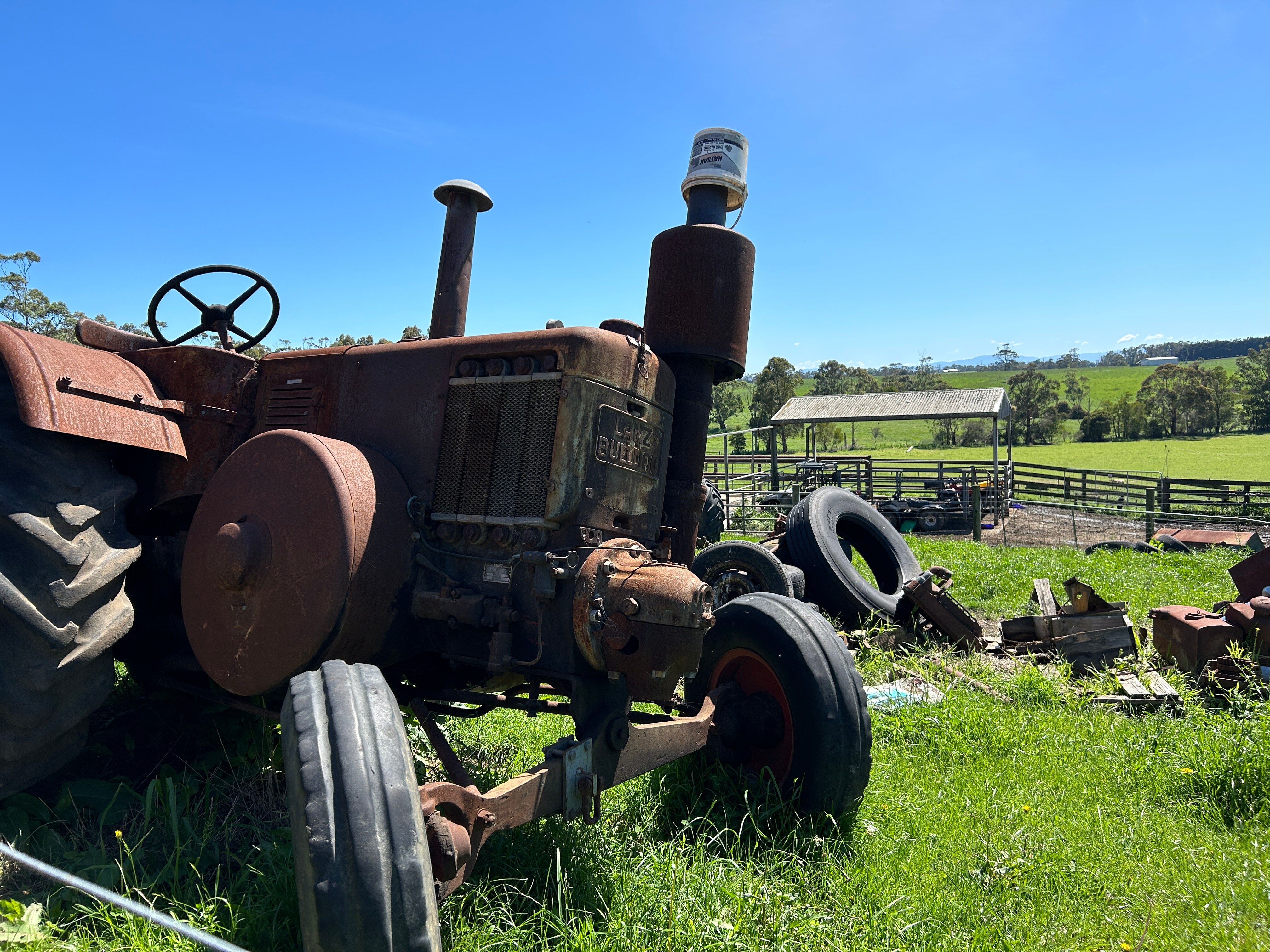 A rusty tractor in a paddock.