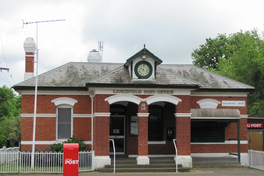 The Lancefield post office in Victoria shows the town clock and the red brick exterior.