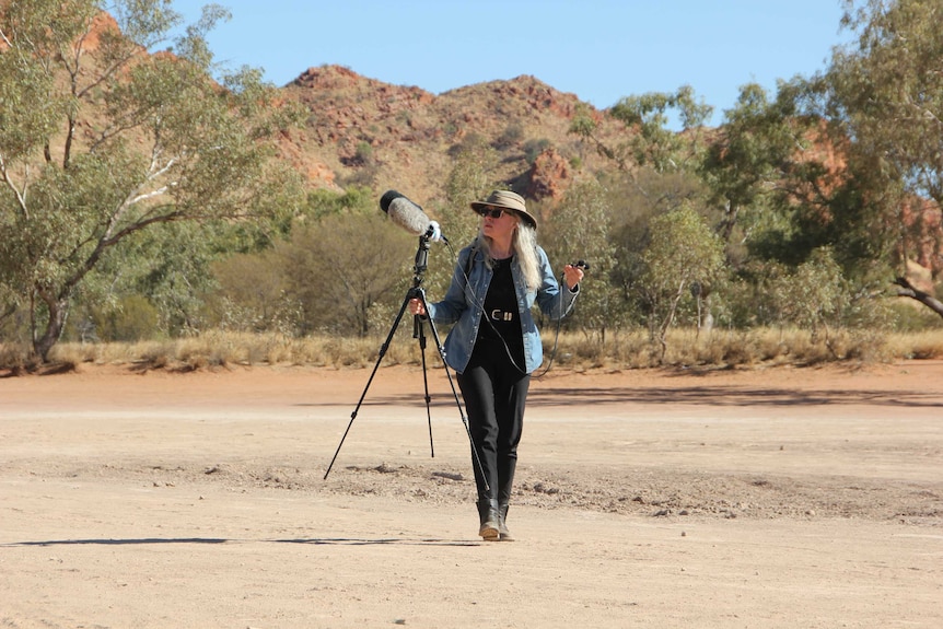 Composer Hollis Taylor with sound recording equipment in the West MacDonnell Ranges.
