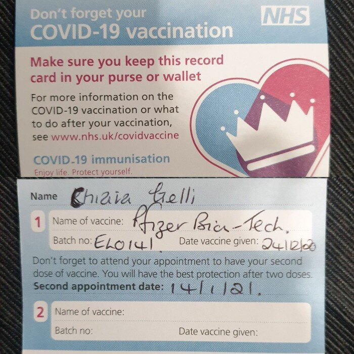 A vaccination card in the UK from both sides with details filled on it.