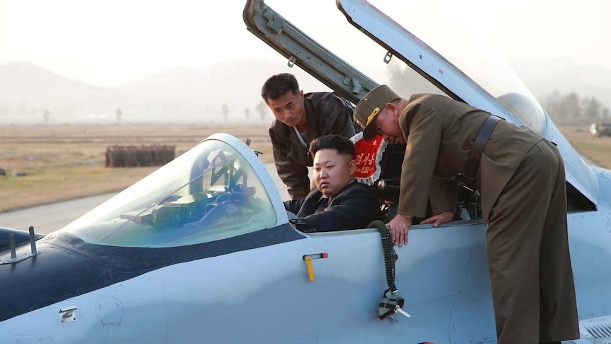 Kim Jong-un sits in a fighter jet.