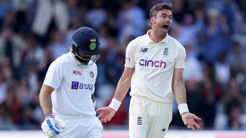 An England fast bowler roars in triumph after getting the Indian captain out in a Test match.
