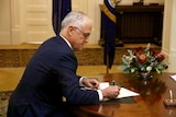 Malcolm Turnbull signs his allegiance to the Queen.