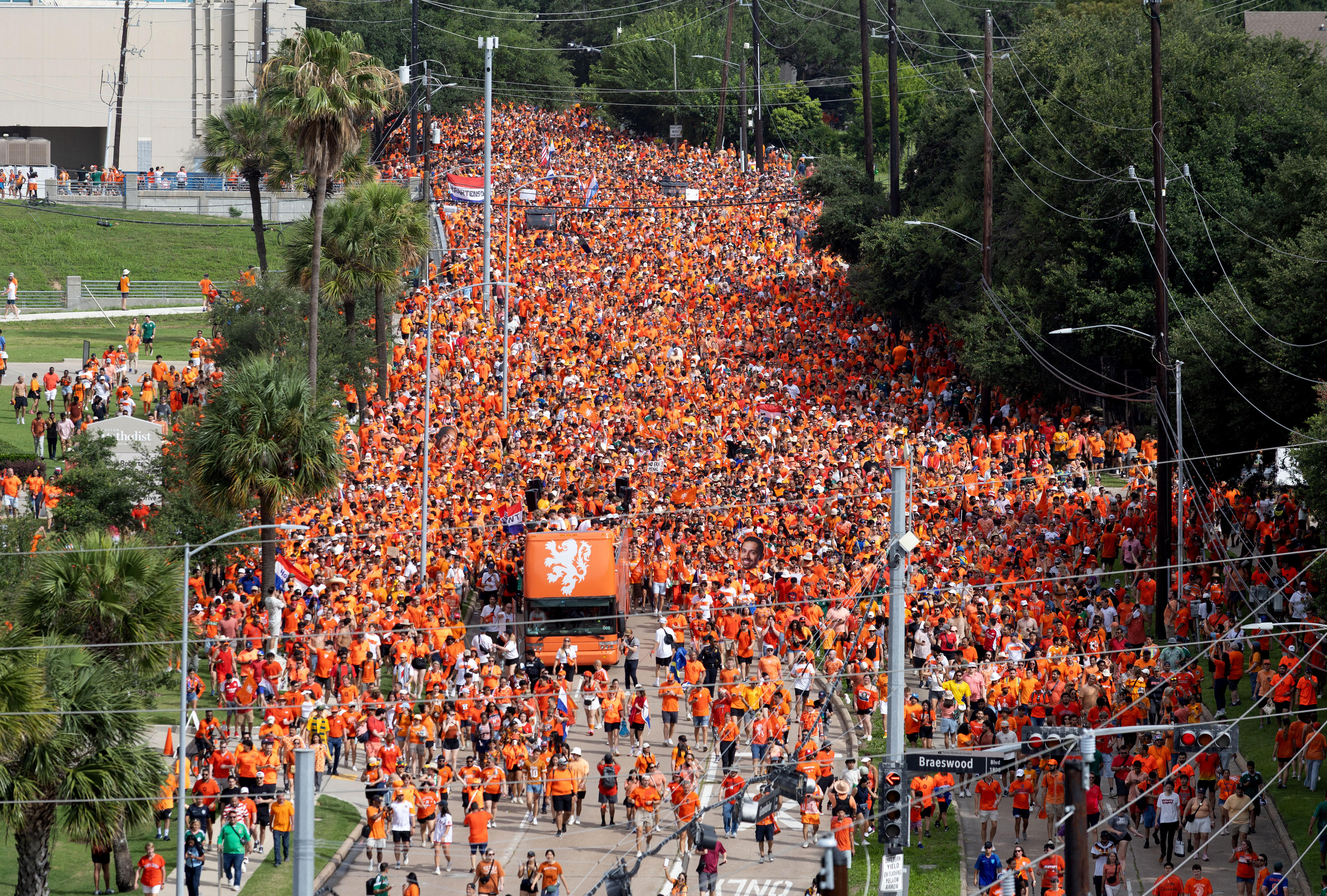 An aerial shot of Dutch fans dressed in orange walking the streets of Boston