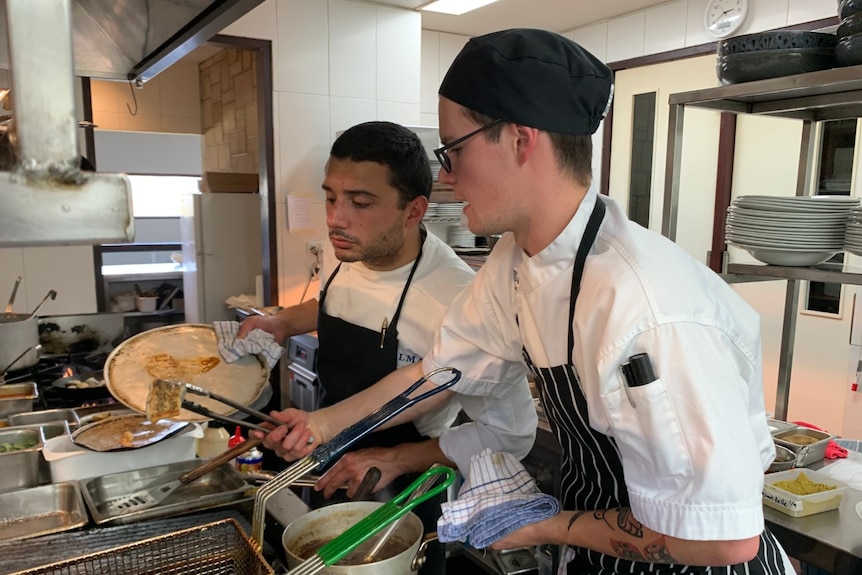 Two young men working in the kitchen of Pepper and Salt restaurant at Forest Hill winery.