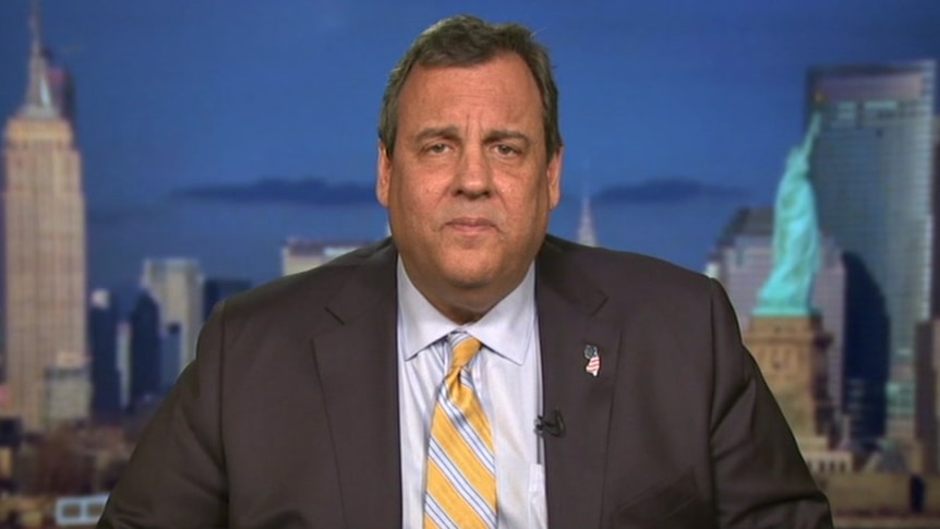 Chris Christie wears a suit and tie.