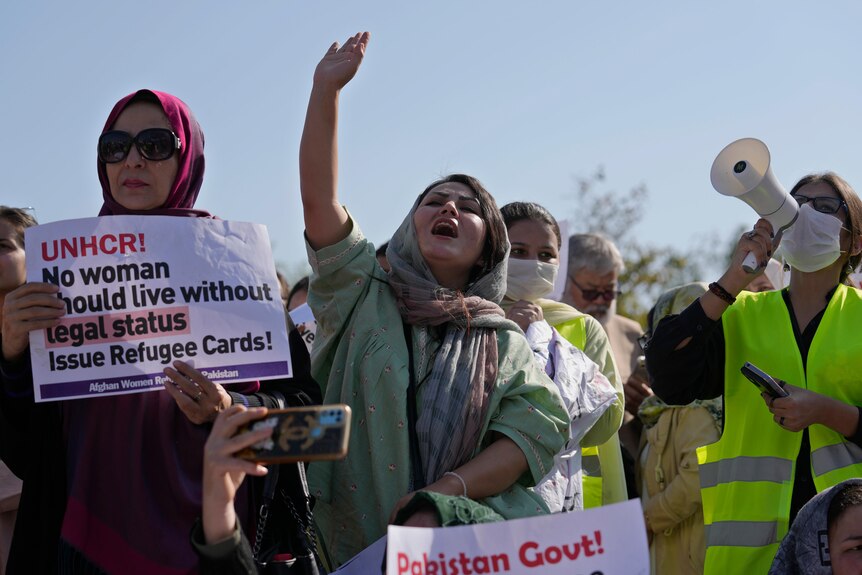 Afghan refugee women participate in a rally to mark International Women's Day.