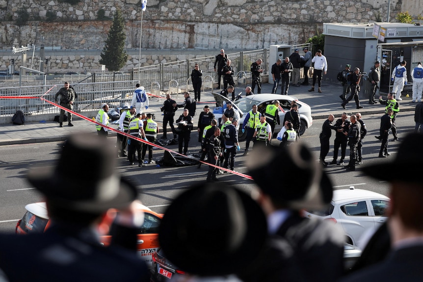 Israeli officials work at the scene of a violent incident in Jerusalem.