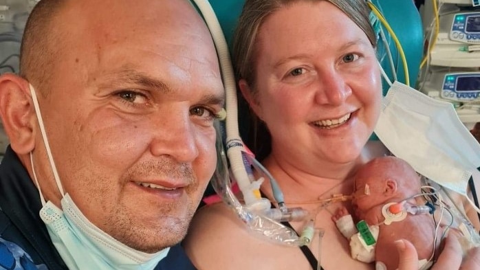 New mum Tegan Wain and new dad Rodney Atkinson cuddle with premature baby Levi