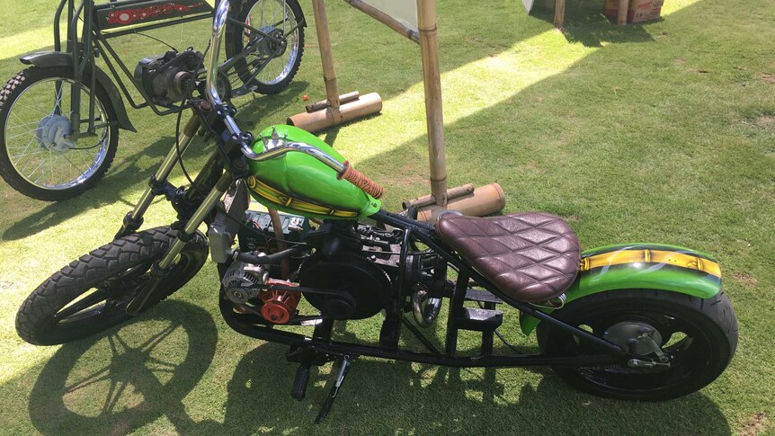 A motorcycle pictured from above on green grass