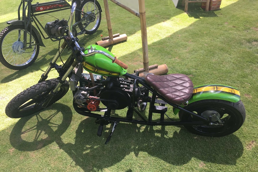 A motorcycle pictured from above on green grass