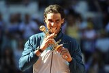 Rafael Nadal poses with his trophy after winning the men's singles final tennis match of the Madrid Masters
