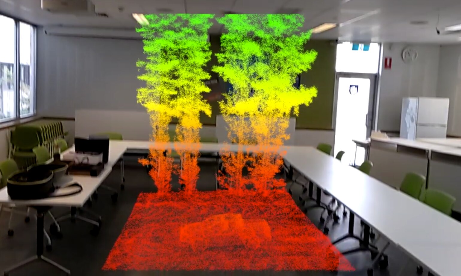 A hologram like image of a small plot of a forest floats in the middle of the room.